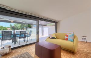 a living room with a yellow couch and a table at Villa Casa Lampadina in Poreč