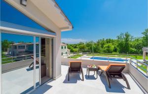 a patio with chairs and a table on a balcony at Villa Anzela in Pula +29 photos