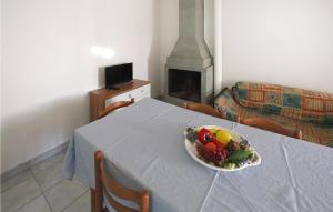 a bowl of fruit on a table with a fireplace at Lovely Apartment In Rosolina Mare in Rosolina Mare