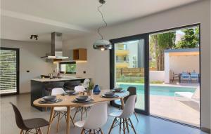 a kitchen and dining room with a table and chairs at Villa Stella Mare in Premantura