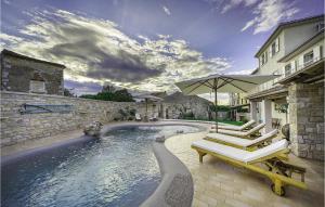 a swimming pool with two lounge chairs and an umbrella at Villa Elizabeta in Umag