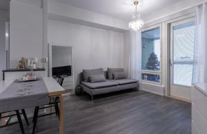 a living room with a couch and a table at North Apartment Riistatie in Rovaniemi