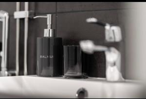 a soap dispenser on a sink in a bathroom at North Apartment Riistatie in Rovaniemi