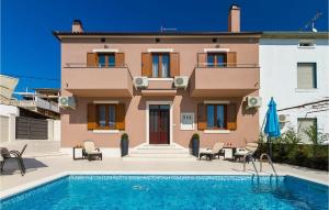 a villa with a swimming pool in front of a house at Villa Miceli in Pula