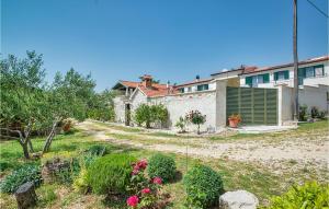 a house with a yard with flowers and plants at Villa Torine in Zadar