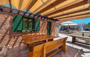 a patio with a wooden bench on a brick building at Villa Kunta in Zadar