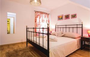 a bedroom with a large bed and a window at 1 Bedroom Nice Apartment In Vrbnik in Vrbnik