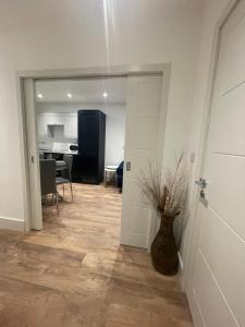 a living room with a door and a vase on the floor at The Duplex at Sophia Mews with free parking in Cardiff +4 photos