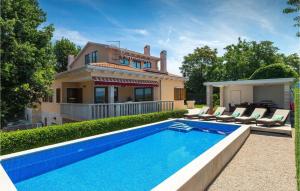 a house with a swimming pool in front of a house at Villa Rosa Labin in Labin