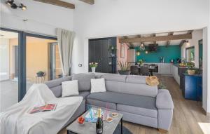 a living room with a couch and a kitchen at Lovely Home In Rovinj in Rovinj
