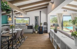 a kitchen and dining room with a table and chairs at Lovely Home In Rovinj in Rovinj