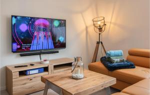 a living room with a television and a coffee table at Amazing Home In Klütz With Kitchen in Klütz