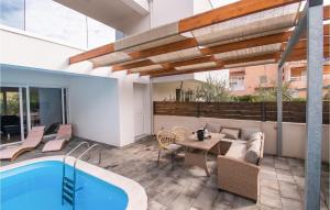 an outdoor patio with a pool and a table and chairs at Villa Vlahov Ii in Šibenik +32 photos