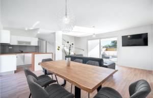 a dining room and living room with a table and chairs at Villa Vlahov Ii in Šibenik