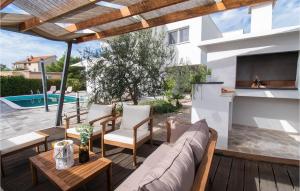 a patio with a couch and chairs and a fireplace at Cld688, Villa Vlahov I in Šibenik