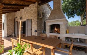 a patio with a wooden table and a fireplace at Villa Maria Selina in Selina