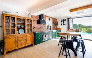 a kitchen with green cabinets and a counter top at Beautiful Home In Pisarovina With Wi-Fi in Lipnica