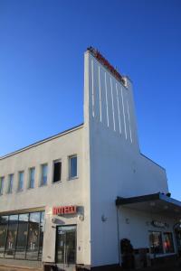 a white building with a sign on the side of it at Hesehotelli Turku Linja-autoasema in Turku