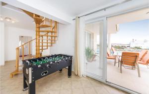 a living room with a foosball table and a staircase at 3 Bedroom Lovely Home In Novalja in Novalja