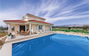 a villa with a swimming pool in front of a house at 3 Bedroom Lovely Home In Novalja in Novalja +31 photos