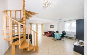 a living room with a staircase and a dining room at 3 Bedroom Lovely Home In Novalja in Novalja