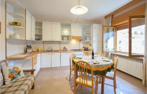 a kitchen and dining room with a table and chairs at Nice Apartment In Sovramonte With Wifi in Sovramonte