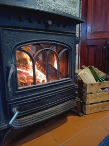 a fireplace with a fire inside of it at Casa da Benfeitoria in Guimarães