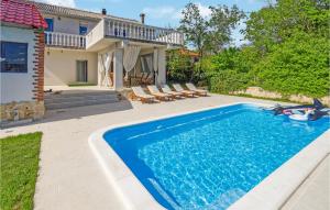 a swimming pool in the backyard of a house at Nice Home In Gornji Muc With Wifi in Gornji Muć