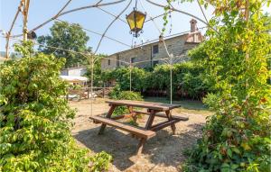 a picnic table in a garden with a hanging light at Cà Di Cerchione in Pieve Santo Stefano