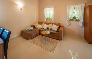 a living room with a couch and a table at Stunning Home In Velika Nedelja in Osluševci