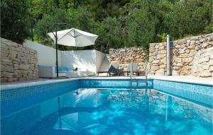a swimming pool with an umbrella and chairs at Villa Olive Tree Pisak in Pisak