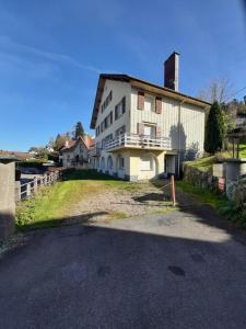 a large white building on the side of a road at F2 lumineux en centre ville - Gerardmer in Gérardmer