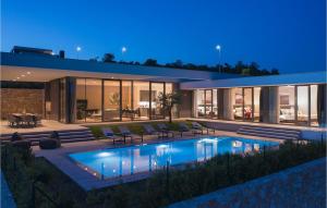 a house with a swimming pool in front of it at Villa Kalipso in Nova Vas