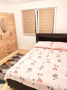 a bedroom with a bed and a dresser at Apartman Duric in Tuzla