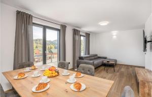 a living room with a wooden table with food on it at Awesome Home In Stari Laz With Kitchen in Stari Laz