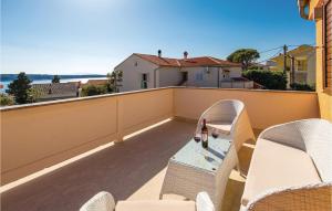 a patio with chairs and a table on a balcony at 4 Bedroom Amazing Home In Barbat in Barbat na Rabu
