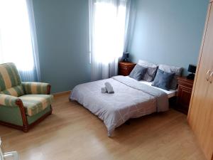 a bedroom with a bed with a chair and a window at Le Coin Cozy in Carhaix-Plouguer +57 photos