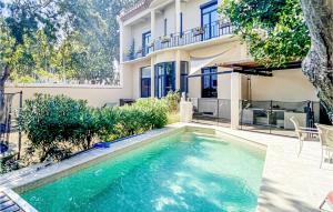 a swimming pool in front of a house at Gorgeous Home In Perpignan in Perpignan