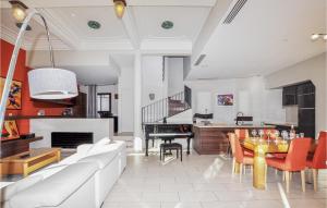 a living room with a white couch and a piano at Gorgeous Home In Perpignan in Perpignan