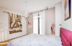 a bedroom with a bed and a painting on the wall at Gorgeous Home In Perpignan in Perpignan