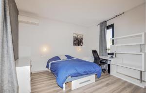 a white bedroom with a bed and a desk at Gorgeous Home In Perpignan in Perpignan