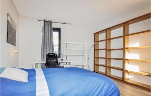 a bedroom with a blue bed and a window at Gorgeous Home In Perpignan in Perpignan