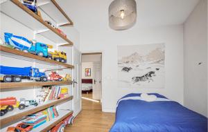 a childs bedroom with a blue bed and shelves at Gorgeous Home In Perpignan in Perpignan