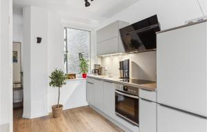 a kitchen with white cabinets and a sink at Pet Friendly Apartment In Naumburg in Naumburg