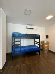 two bunk beds in a room with a barrel at ALPACA DEPARTAMENTOS in Cafayate