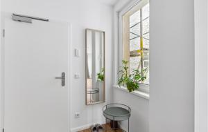 a hallway with a glass table and a mirror at Pet Friendly Apartment In Naumburg in Naumburg +4 photos