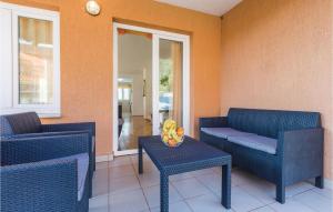 a patio with two chairs and a table and a couch at 3 Bedroom Lovely Home In Savudrija in Savudrija