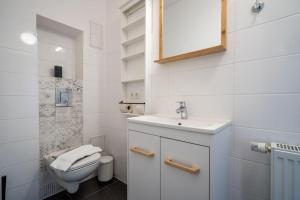 a white bathroom with a sink and a toilet at Haus-kl-Mueritz in Rechlin +15 photos
