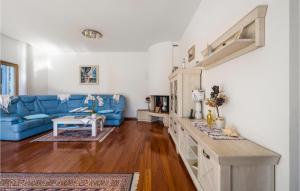 a living room with a blue couch and a table at 4 Bedroom Cozy Home In Vodice in Vodice