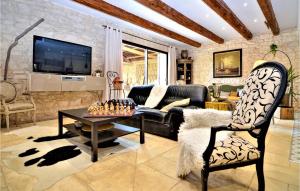 a living room with a couch and a table at Five Bedroom Gorgeous Home In Tarascon in Tarascon